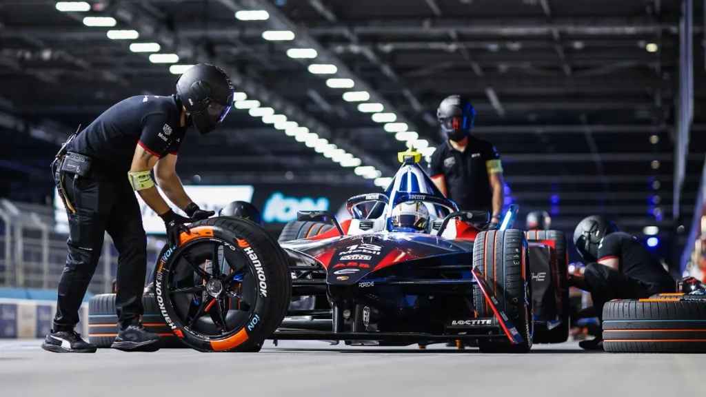 The pit crew preparing a Hankook iON race tire for a Formula E car.