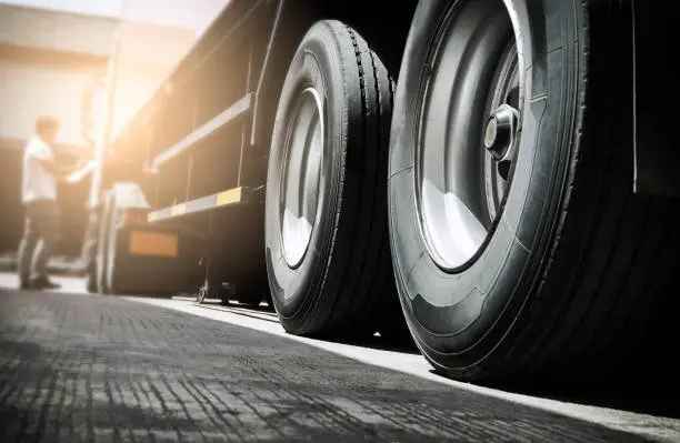 A close-up of a commercial trailer&#39;s wheels, representing the durability of General Tire for fleets.